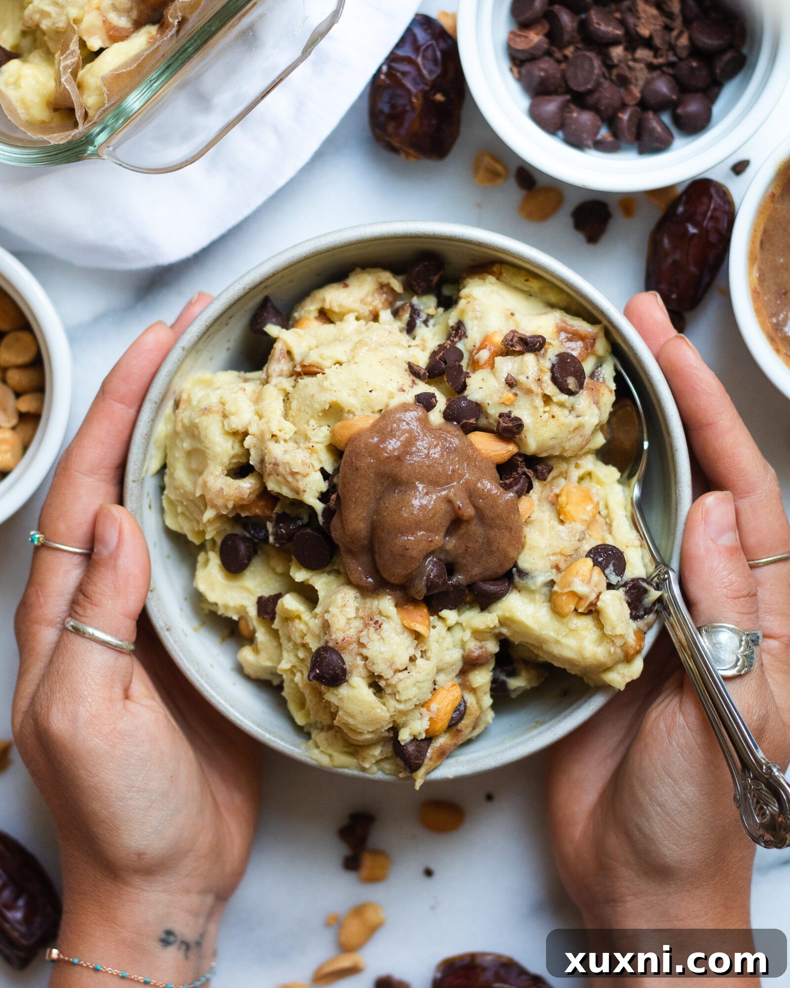 hands holding bow of vegan snickers ice cream