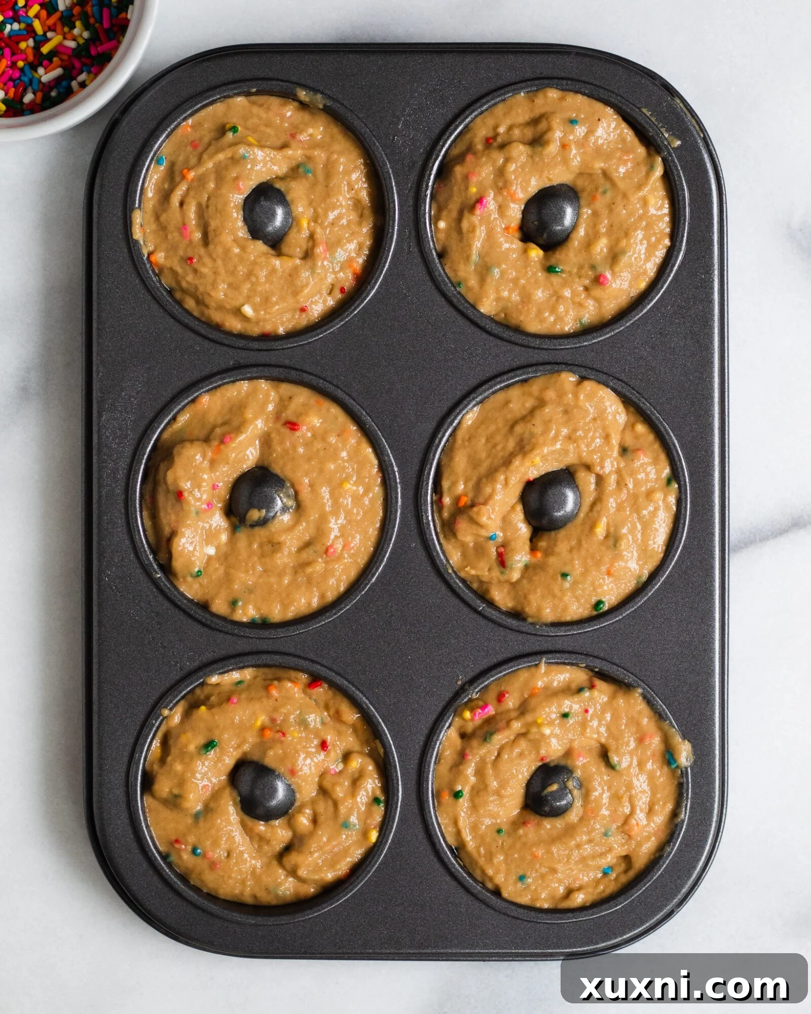 Vegan Birthday Donut Delights 14 vegan vanilla donut batter in the donut pan before baking