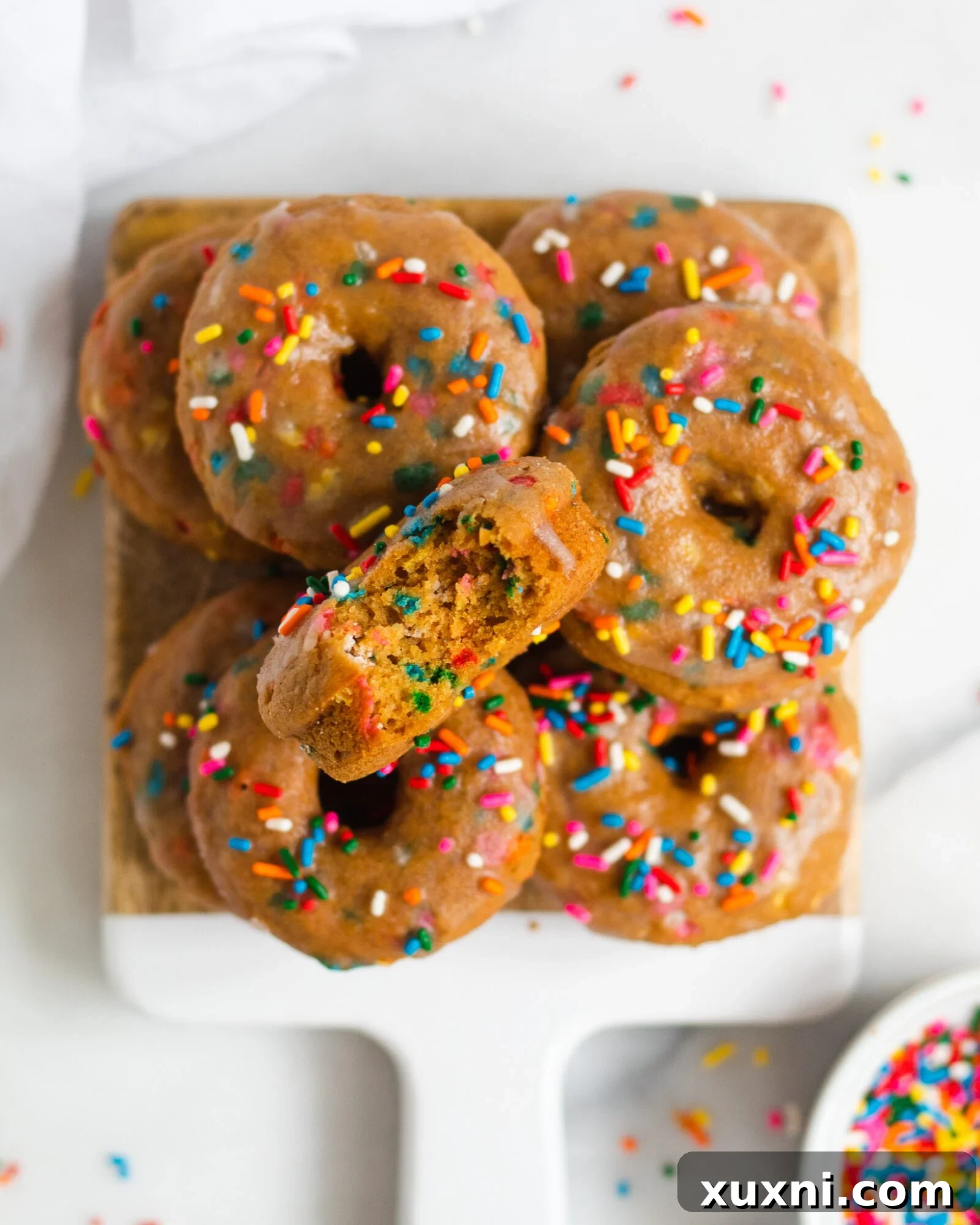 Vegan Birthday Donut Delights 6 baked vegan vanilla donuts on wooden board