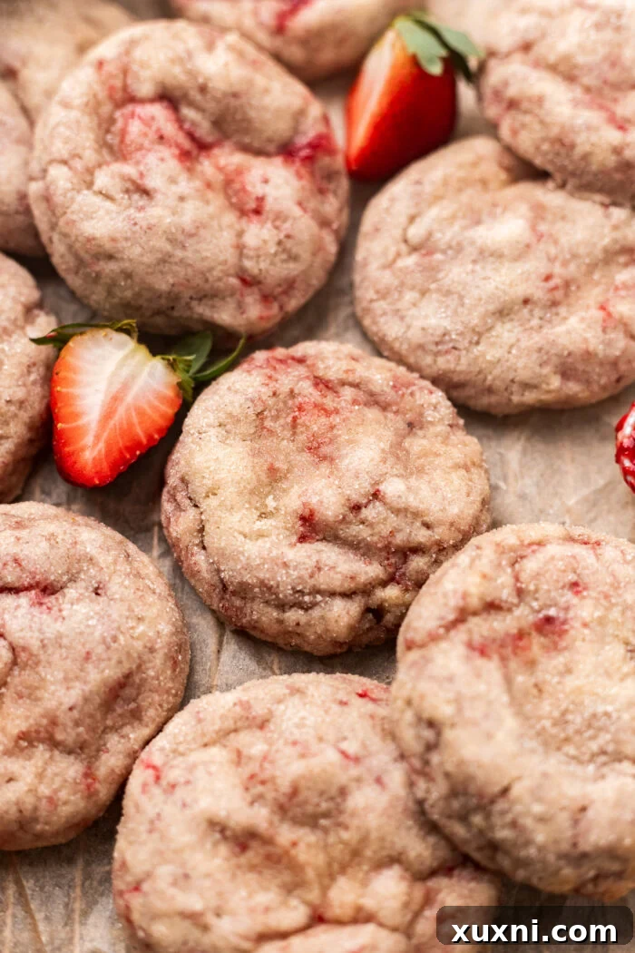 pillowy strawberry cheesecake cookies on parchment paper