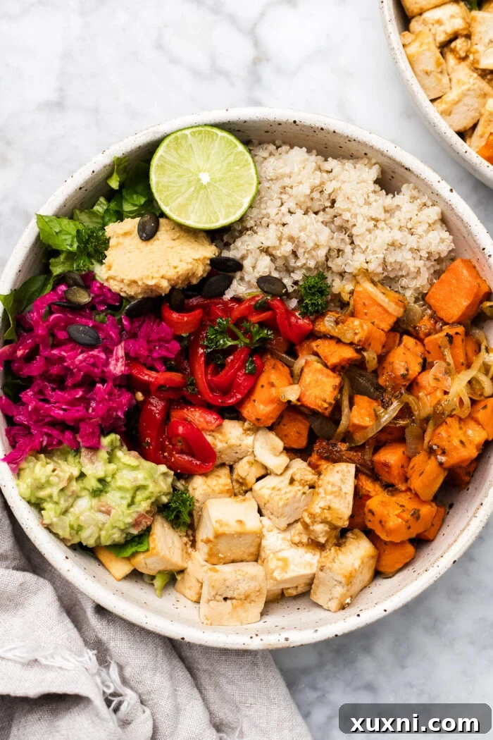 Vibrant roasted sweet potato tofu bowls on a clean marble surface, ready to be served.