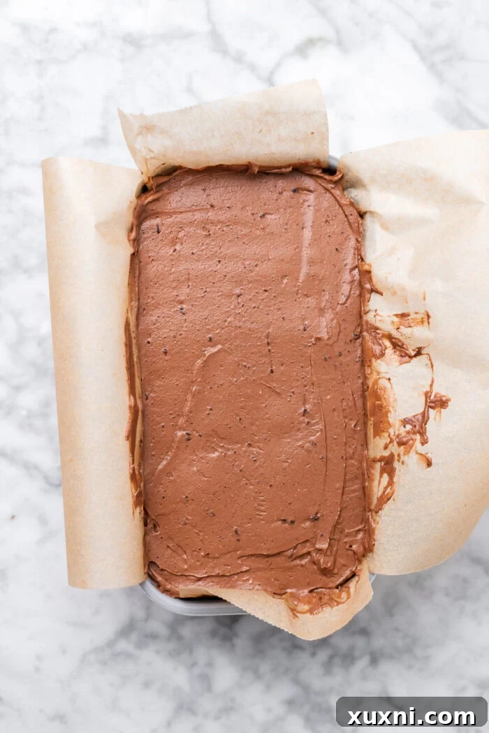 The brownie and cheesecake layers assembled in the loaf pan, pre-baking.