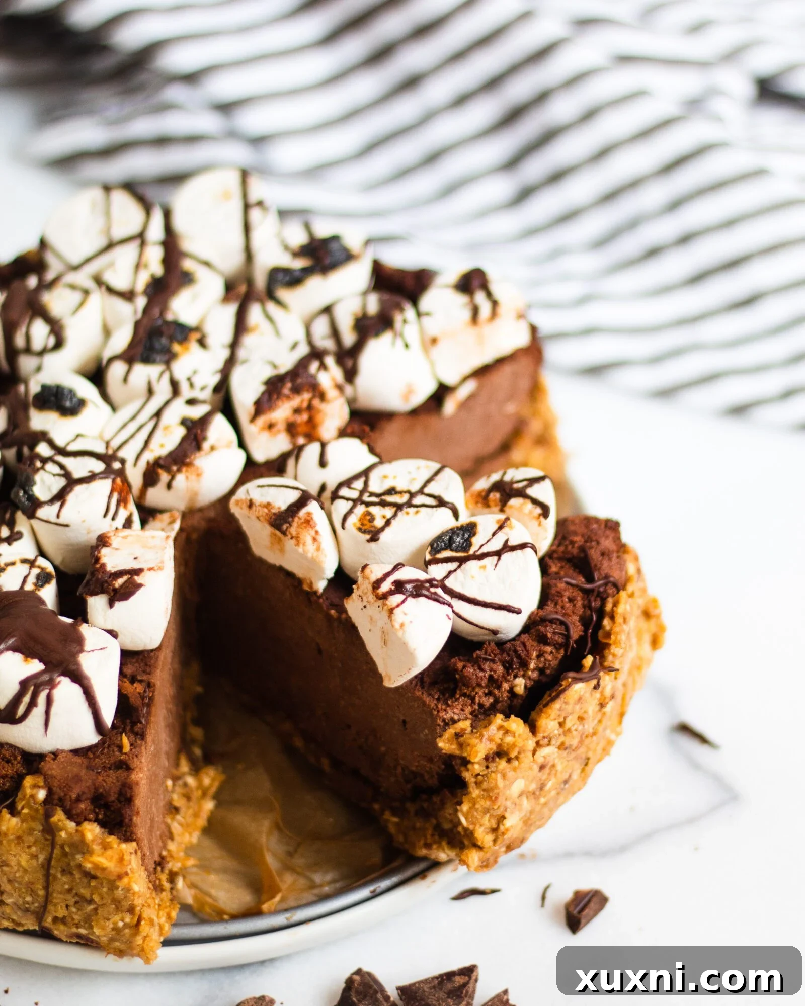 slice of s'mores pie in full pie