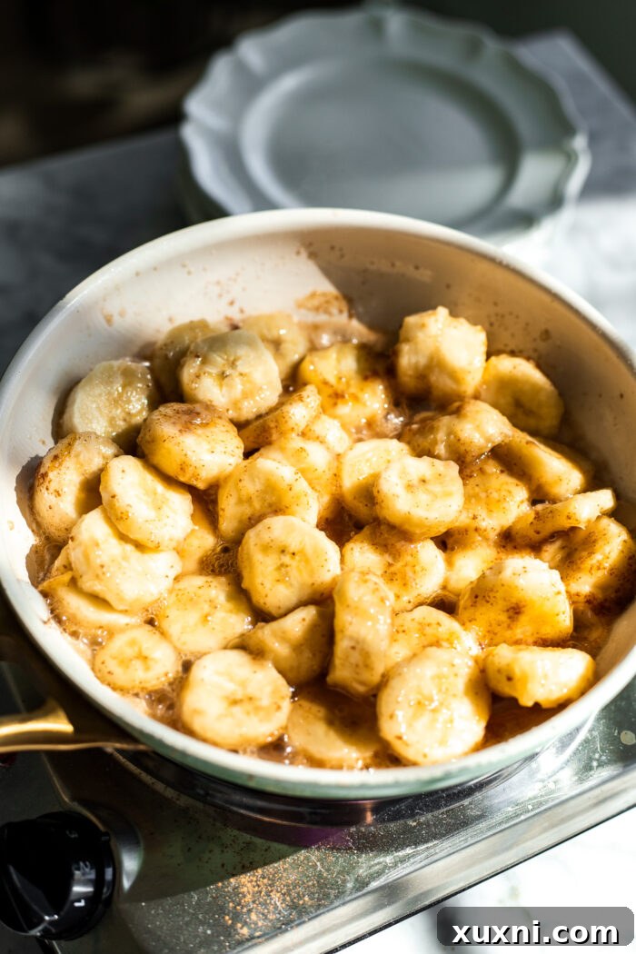 caramelized bananas in a pan, showing brown butter flecks