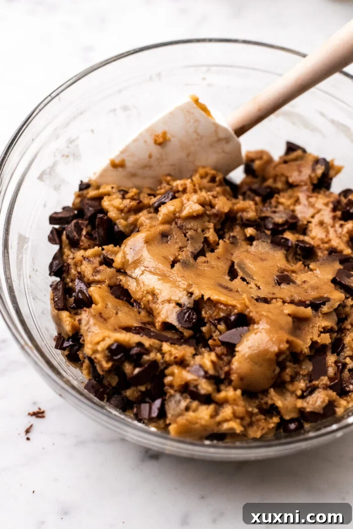 Image showing the preparation of the cookie dough for the vegan cookie cake in a mixing bowl.