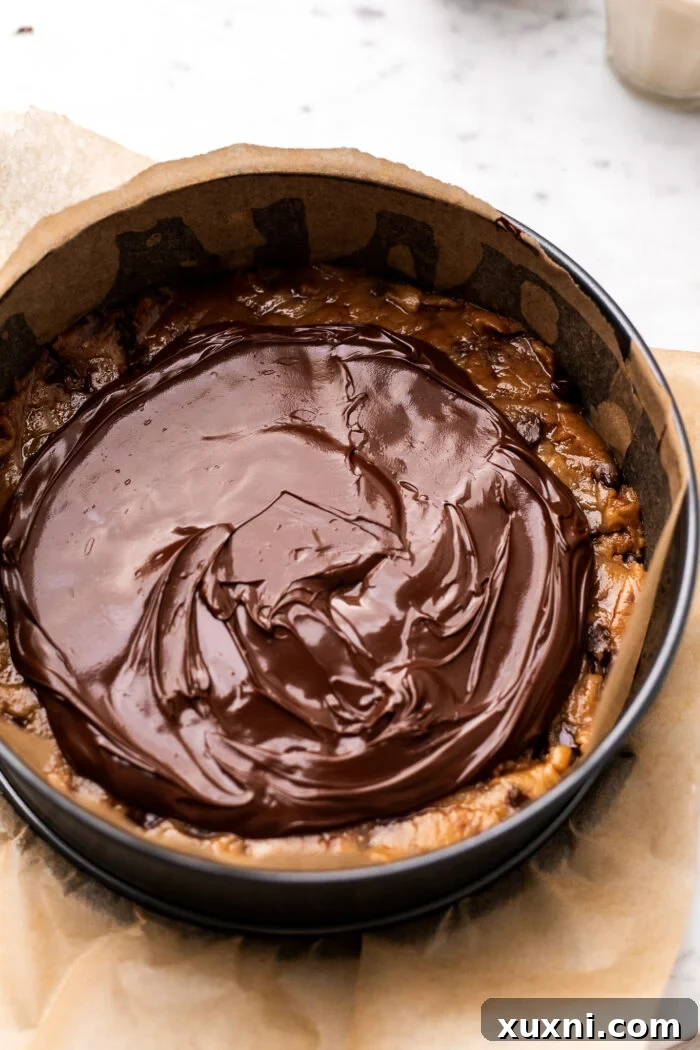 Image showing the vegan Nutella filling spread evenly over the cookie dough, leaving a border.