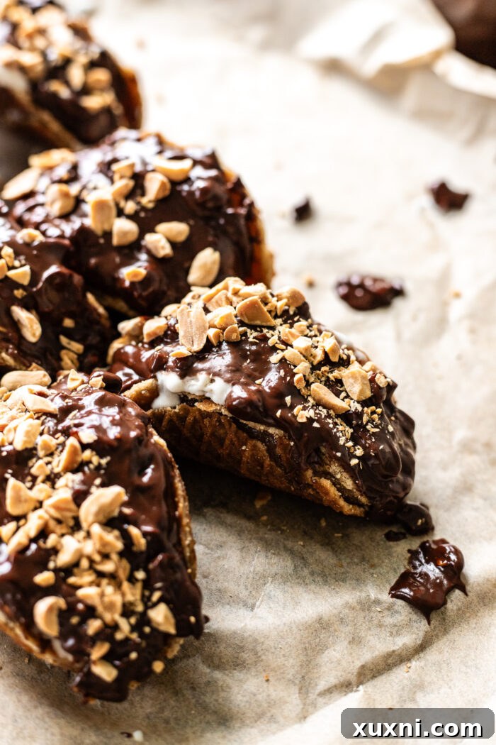 Molding a warm, flexible stroopwafel over a rounded utensil, such as an ice cream scoop handle, to create a perfect mini taco shape.
