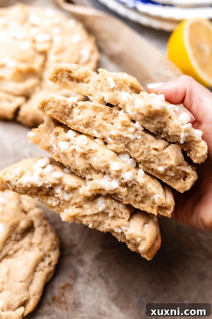 hand holding broken vegan lemon white chocolate cookie