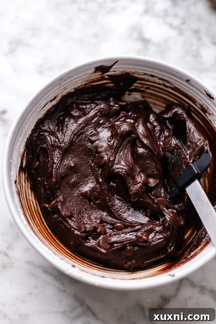 Plant-Powered Brookie Basque Cheesecake Bars for Small Cravings 5 Mixing rich, fudgy vegan brownie batter, ready for the cheesecake base.