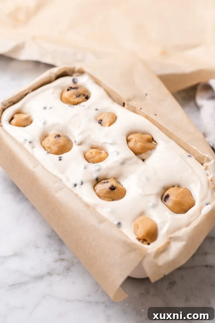 Plant-Powered Brookie Basque Cheesecake Bars for Small Cravings 9 Gently pressing portions of cookie dough into the creamy cheesecake batter for a marbled effect.