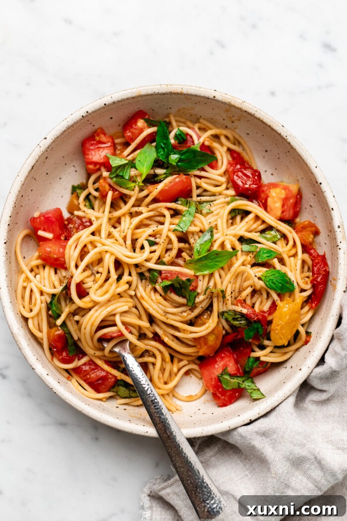 bruschetta pasta in a bowl with a fork