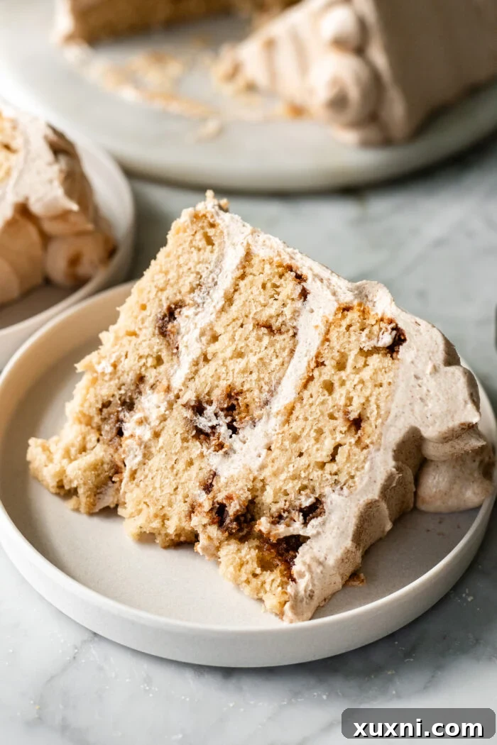 A perfectly sliced vegan snickerdoodle cake on a white plate