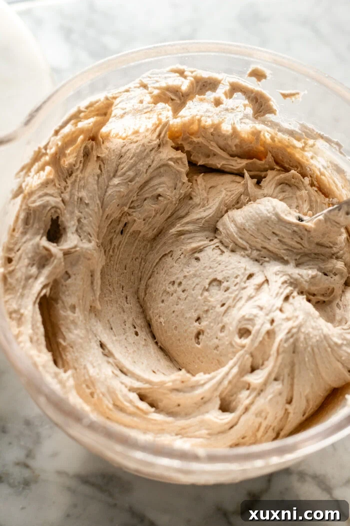 Cinnamon cream cheese frosting in a mixing bowl, ready for application