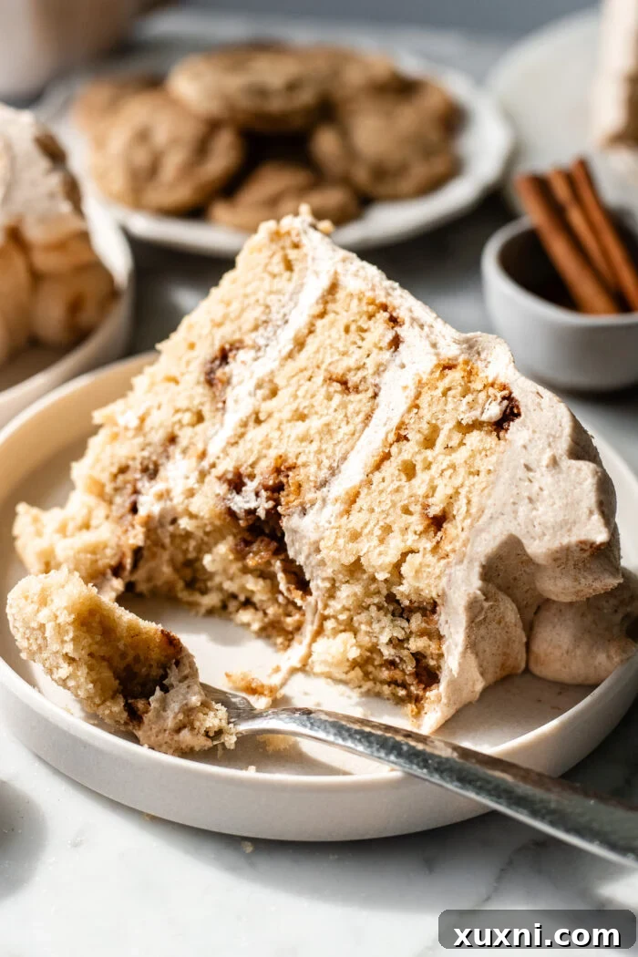 A bite taken from a slice of vegan snickerdoodle cake