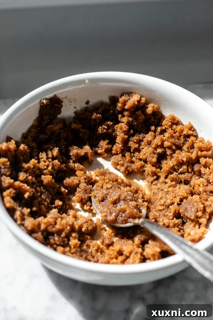 A bowl filled with dry and wet ingredients for the cinnamon crumble, stirred until combined and ready to be set aside.
