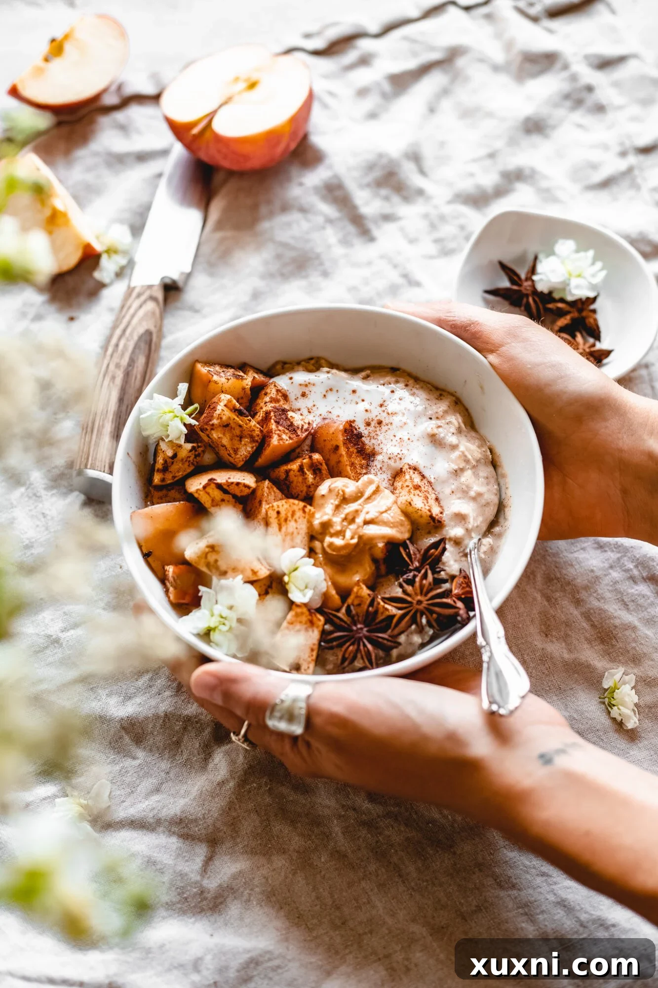 hands holding bowl of overnight oats