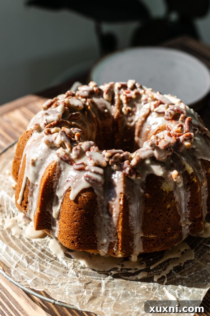 decorated pumpkin bundt cake with thick maple pecan glaze