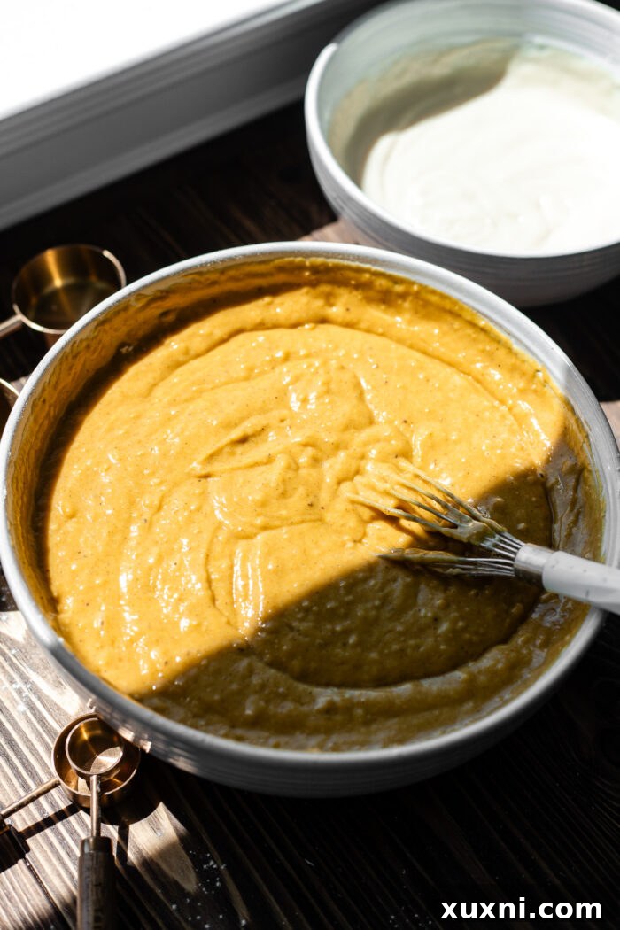 bowl of pumpkin cake batter ready for assembly