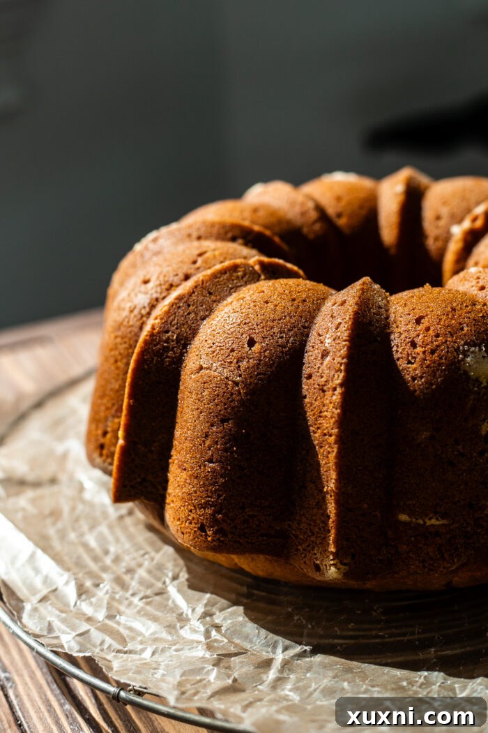 inverted pumpkin bundt cake on a cooling rack