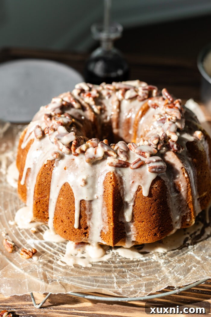 decorated vegan pumpkin bundt cake with maple pecan glaze