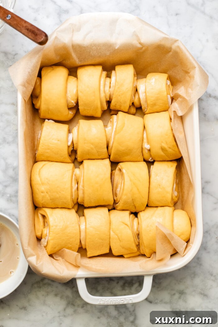 Rolled dough strips placed in a baking pan for a second rise.