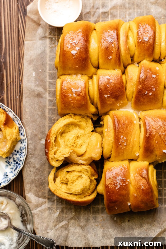 pulled apart Parker house rolls on parchment paper