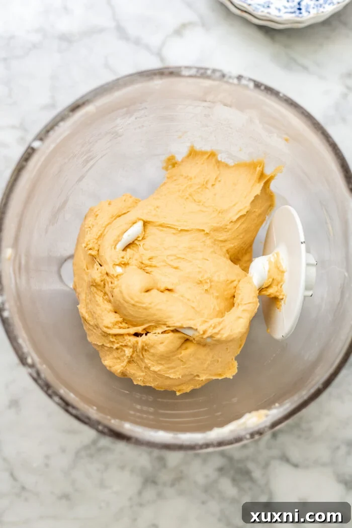 Dough being kneaded in a stand mixer.