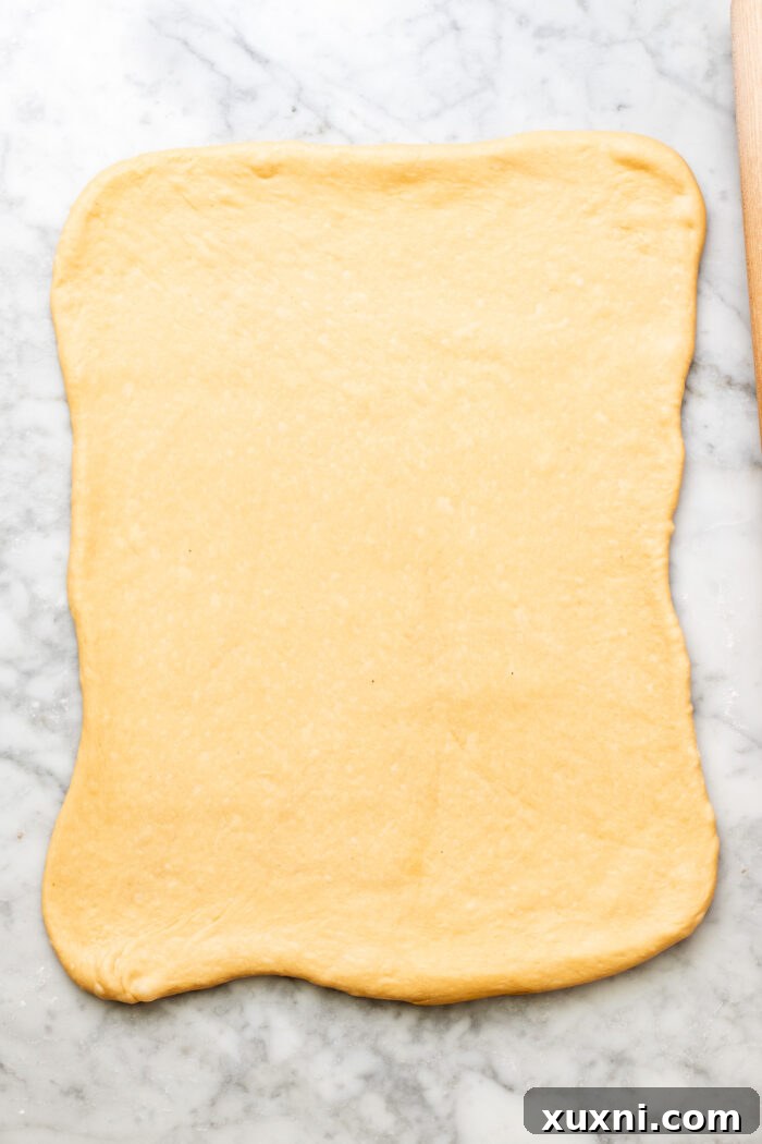 Dough rolled out and spread with salted maple butter.