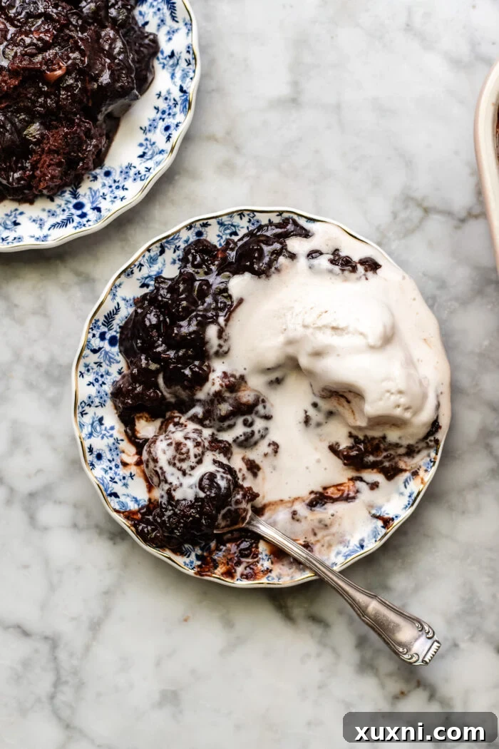 A warm, empty plate after enjoying a delicious serving of the self-saucing chocolate pudding cake, with chocolate streaks remaining.