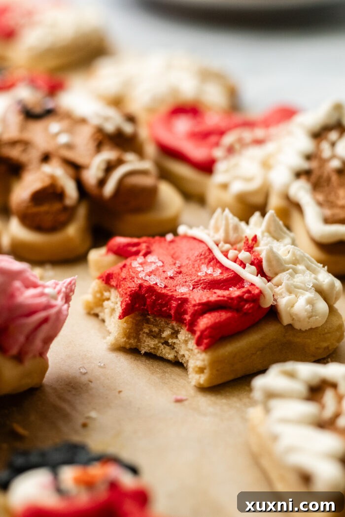Soft Baked Frosted Dairy-Free Sugar Cookies with Vegan Cream Cheese Frosting 3 A close-up of a bitten vegan cream cheese sugar cookie, showing its soft texture