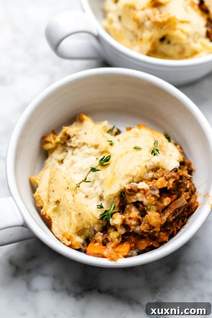 served vegan lentil shepherd's pie in a Dutch oven with a serving spoon