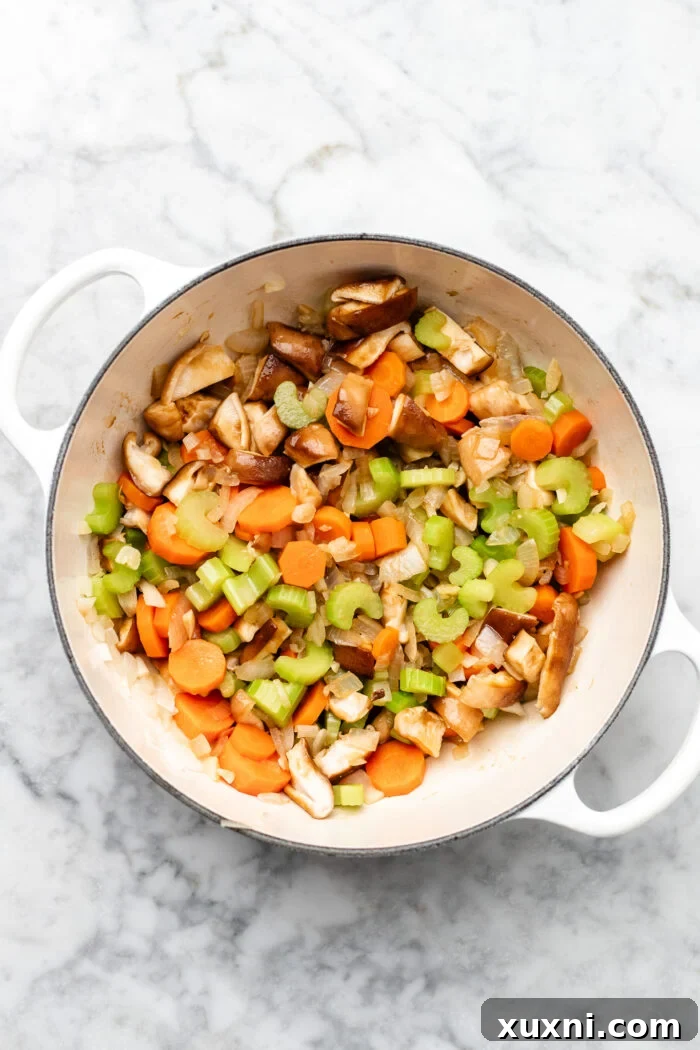 cooking diced onions, carrots, and celery for the lentil filling