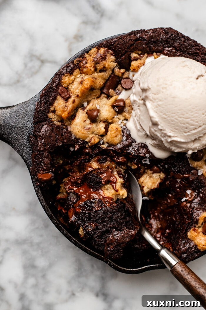 A serving of vegan mini cookie skillet, showing the soft, warm interior and gooey Nutella filling, ready to be enjoyed.