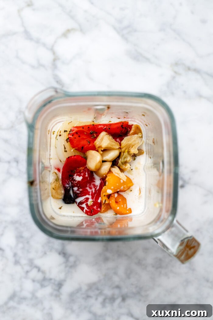 roasted bell peppers, onions, shallots, and garlic on a baking sheet before blending