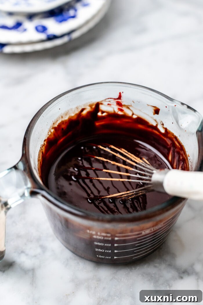Preparing the vegan fudge sauce for red velvet brownies.