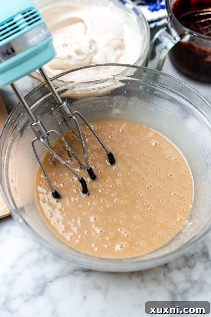 Whisking the wet ingredients for vegan red velvet brownie batter until sugar is dissolved.