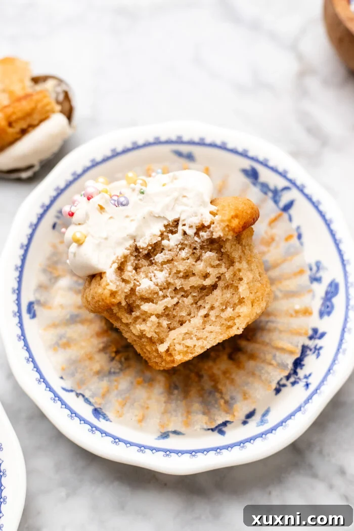 bitten small batch vanilla cupcake revealing its soft, fluffy interior