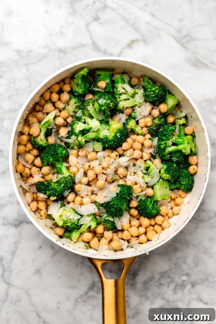 sautéing the onions, broccoli, chickpeas, and herbs together