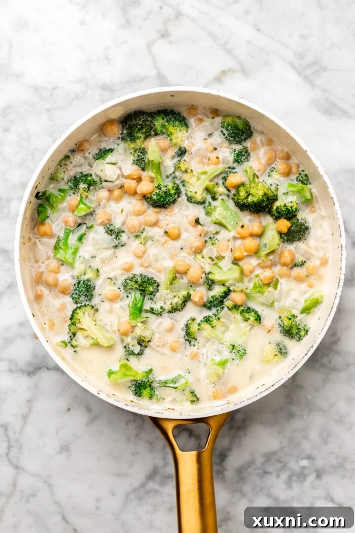 stirring in the dairy free milk and veggie broth