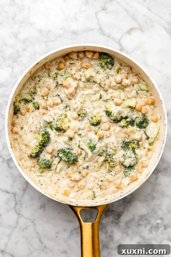 finishing the chickpea broccoli alfredo skillet