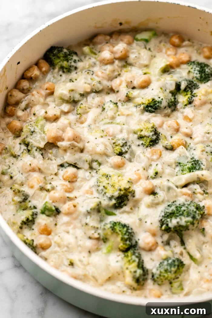 serving the chickpea broccoli alfredo skillet