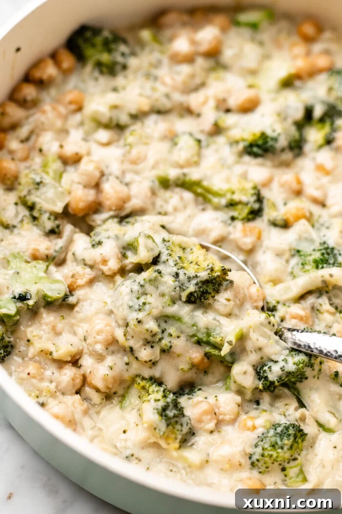 scooping the chickpea broccoli alfredo skillet