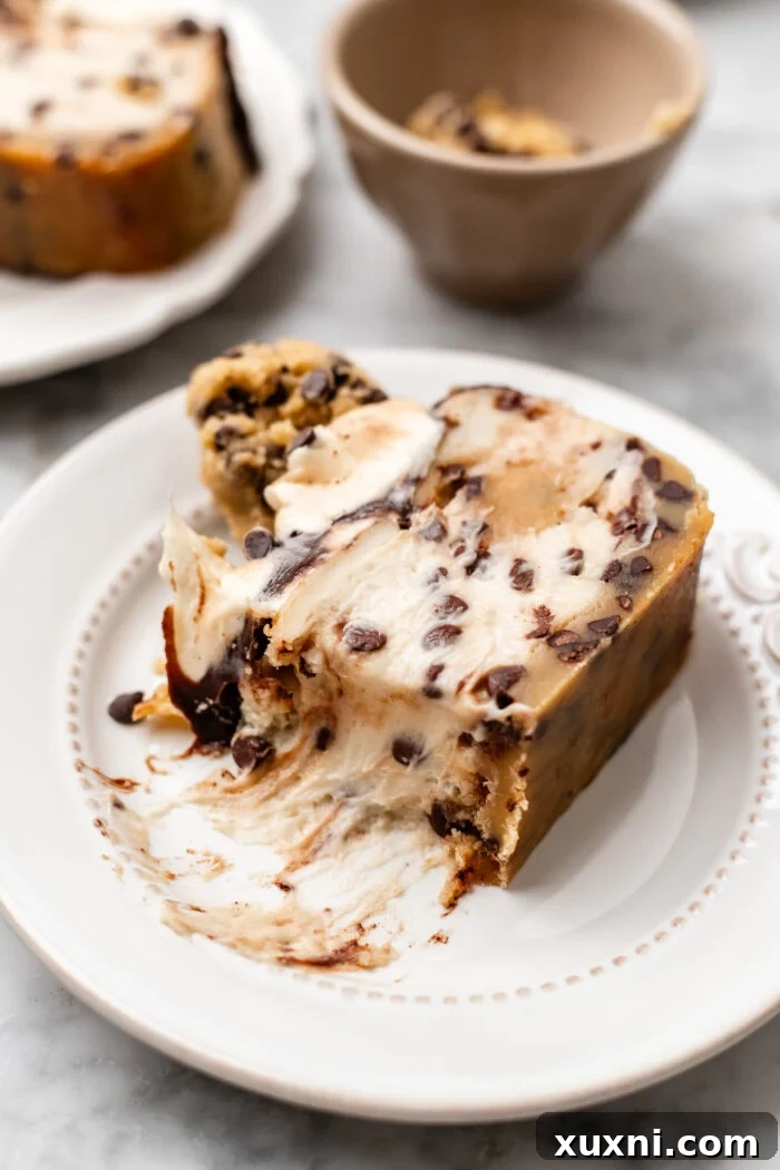 bitten slice of small batch vegan cookie dough cheesecake on a white plate