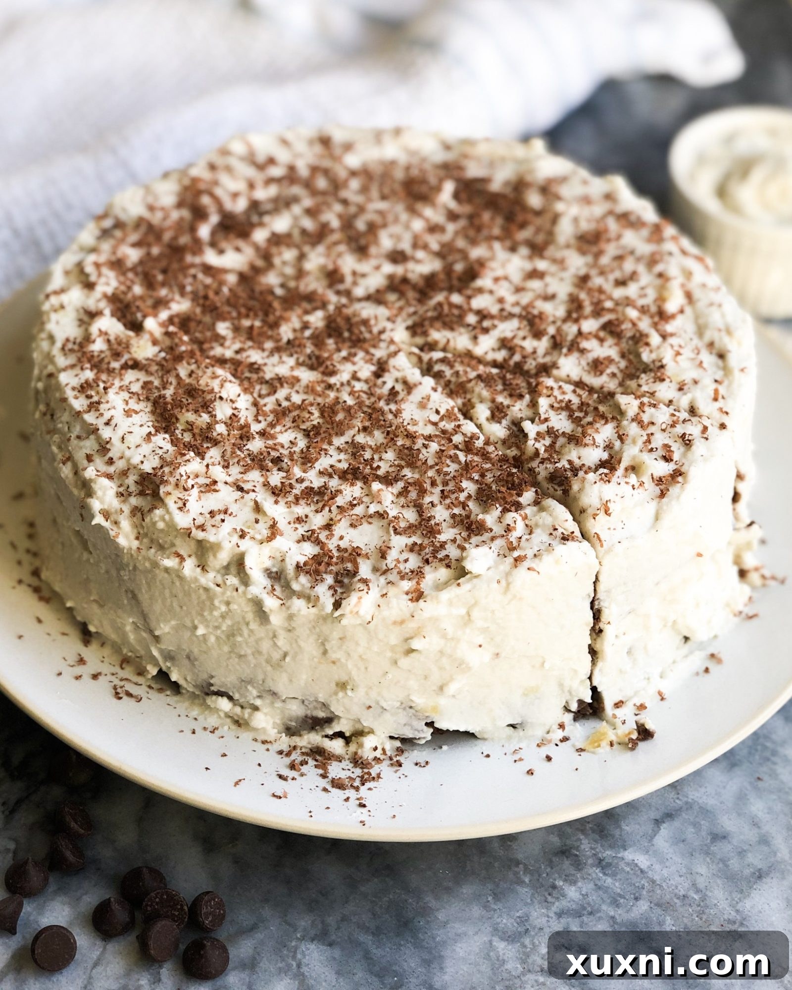 A beautifully presented, decadent paleo chocolate birthday cake with coconut cream frosting, showcasing a healthy, gluten-free, and refined sugar-free treat. Made with sweet potato, it offers an extraordinarily fudgy texture.
