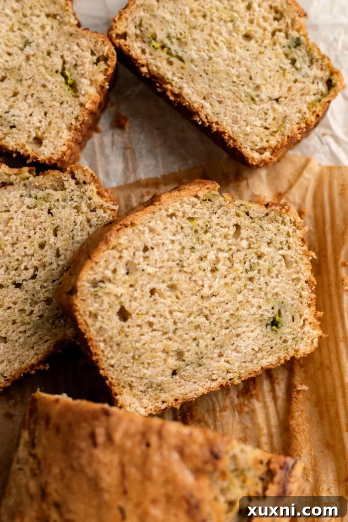 Unbelievably Moist Vegan Zucchini Bread 11 slices of zucchini bread on parchment paper