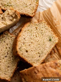 sliced vegan zucchini bread on parchment paper