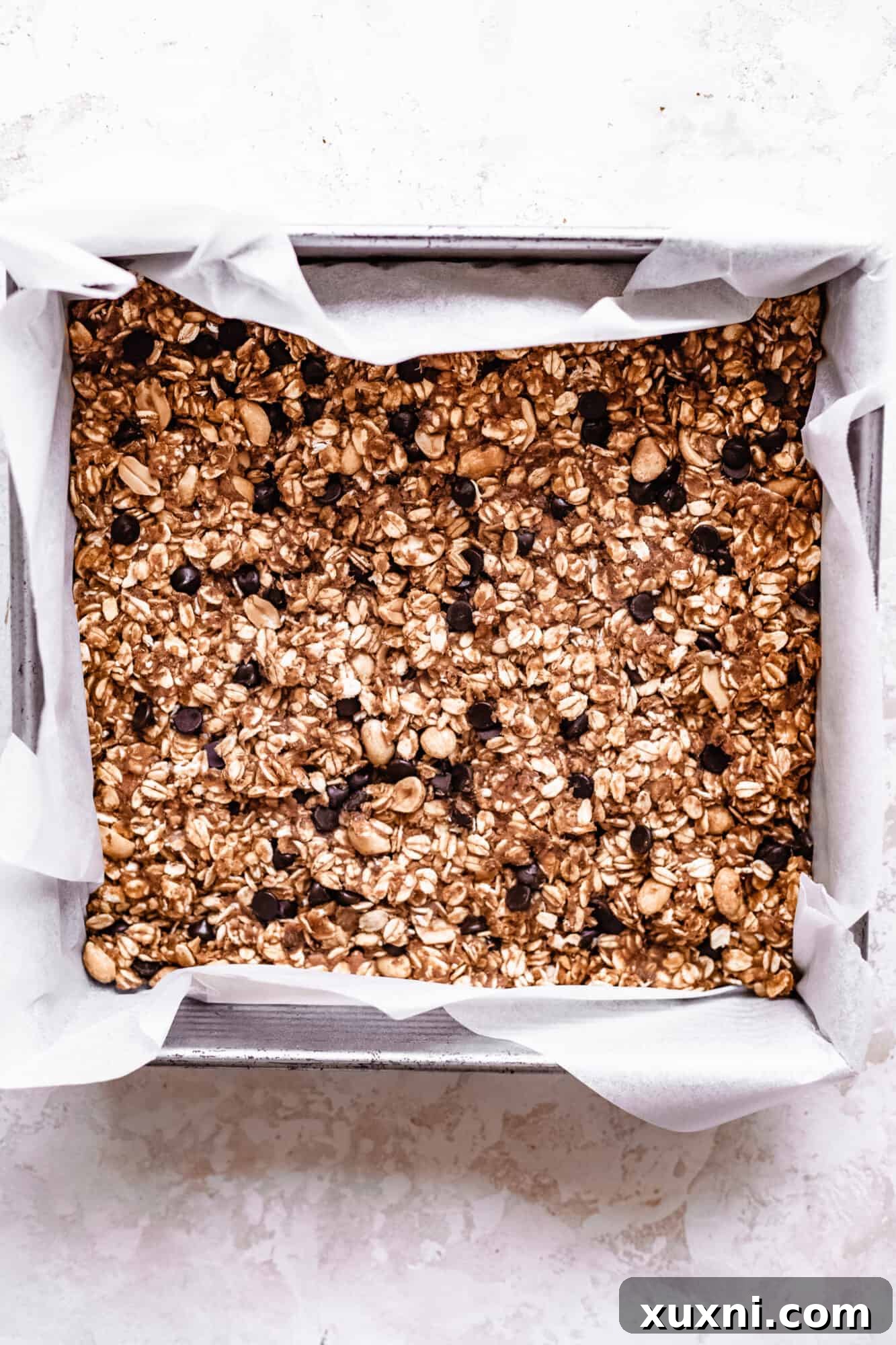 Raw granola bars pressed into a pan