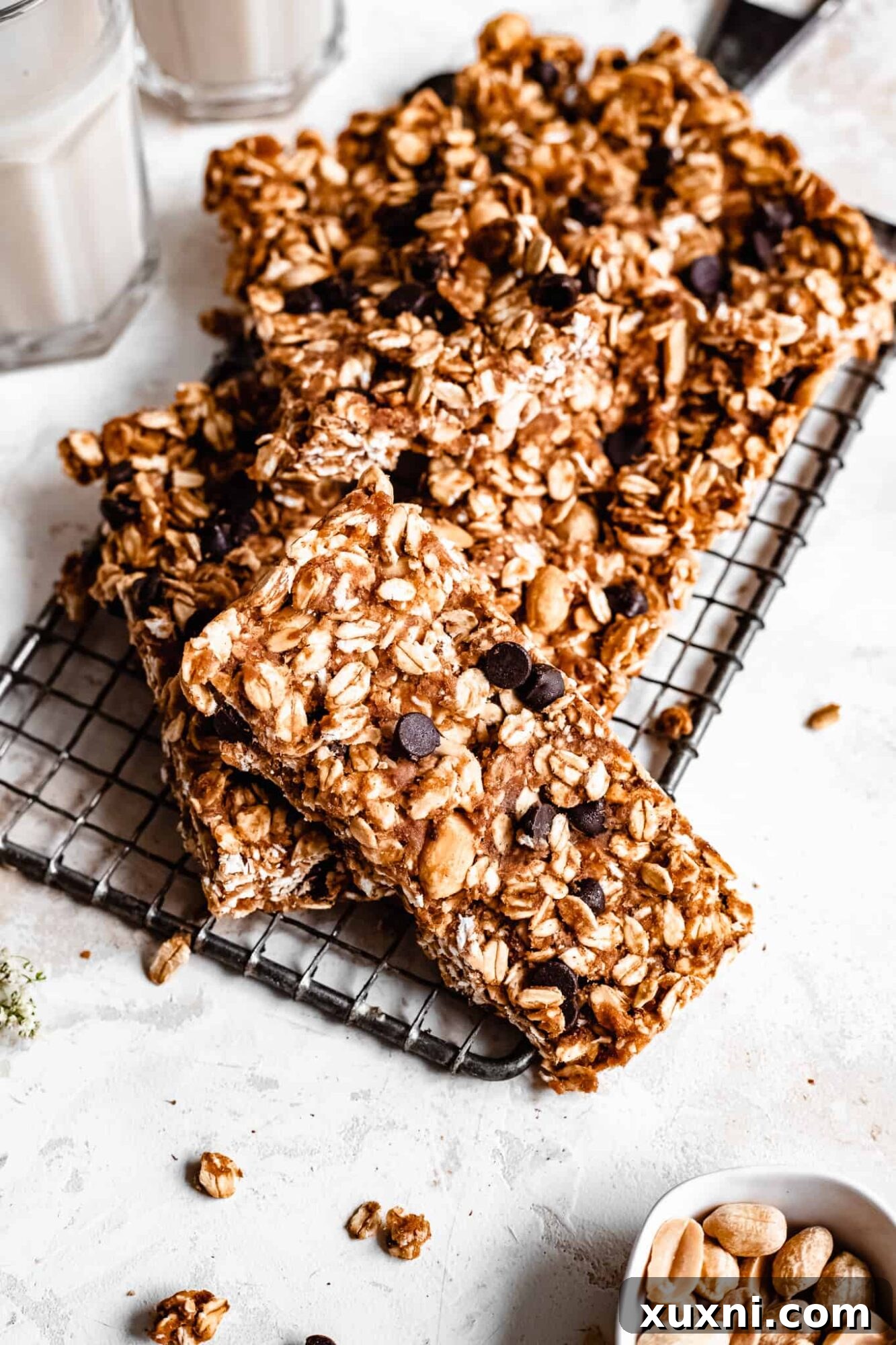Close up of healthy granola bar on cooling rack with a pinch bowl of peanuts