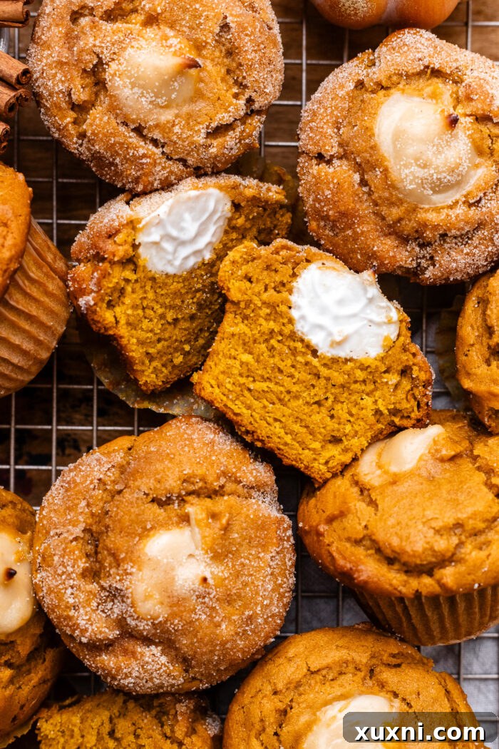sliced vegan pumpkin muffins revealing cream cheese filling
