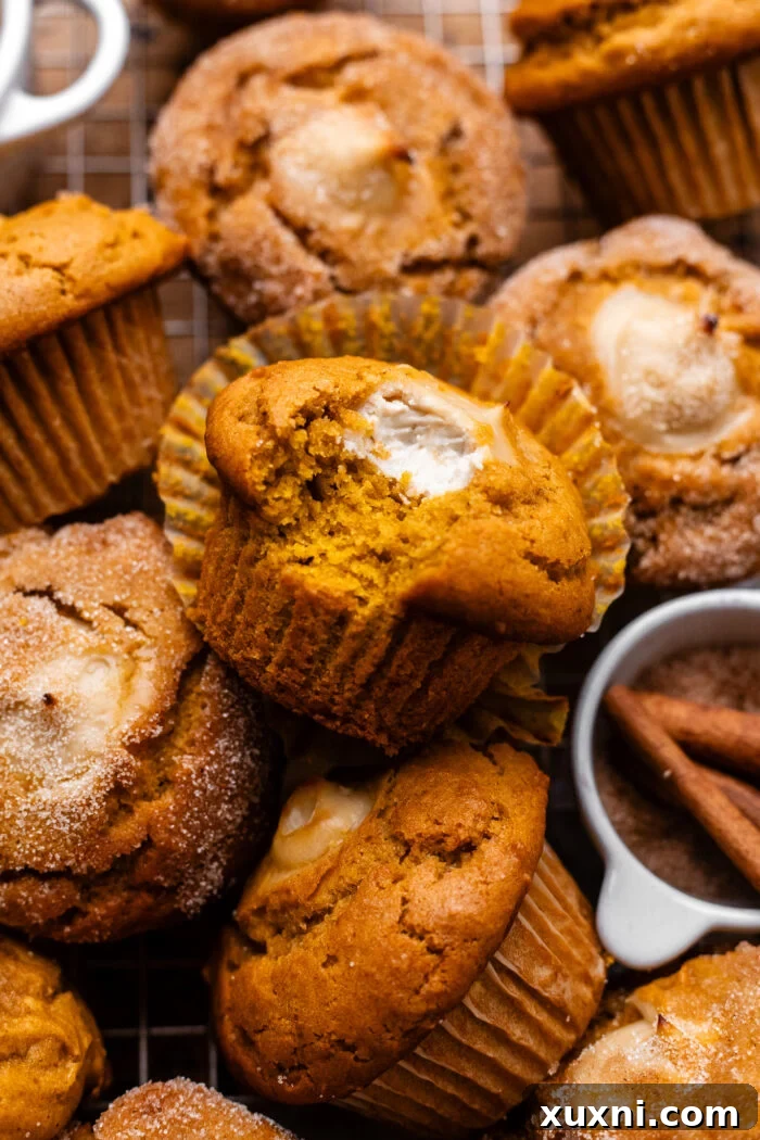 bitten vegan pumpkin muffin with cream cheese filling visible